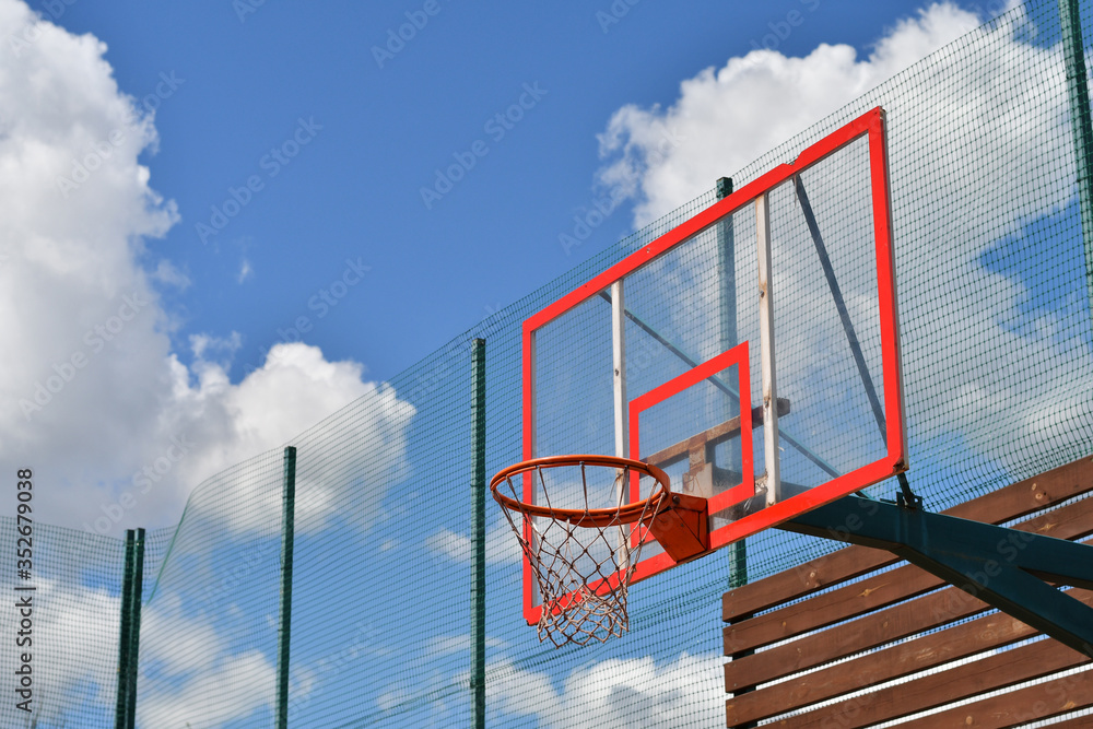 New basketball hoop on outdoor playground, background of blue sky. New basketball hoop on outdoor playground, background of blue sky.