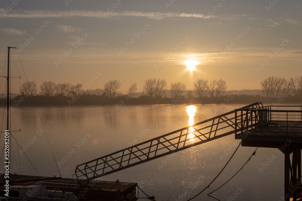 small pier on the river at sunrise