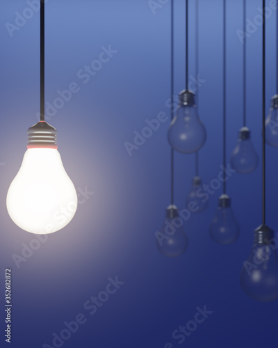 One lit light bulb with multiple light bulbs in background