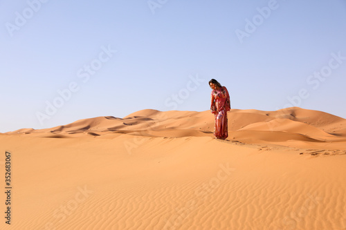 A girl in a beautiful Moroccan dress. Merzouga Morocco. photo