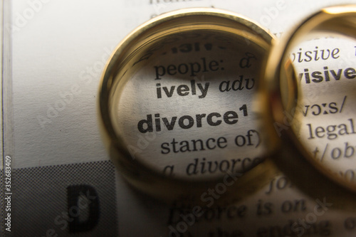 Divorce and separation concept. Two golden wedding rings. Dictionary definition