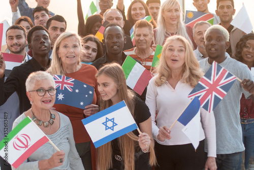 participants of the international forum with their national flags standing together photo