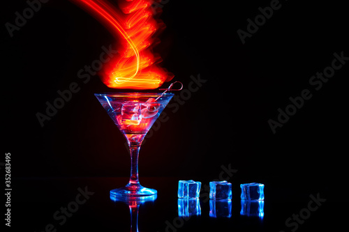 Neon martini glass shot with long exposure. Red club lights.