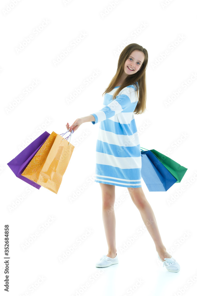 Teenager girl shopping in a store with large paper bags. Teenager girl shopping in a store with large paper bags.
