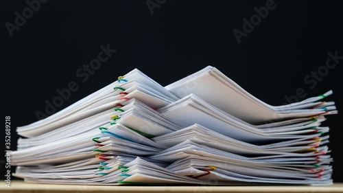 Stack overload document report paper with paperclip place and copy space on green background, business concept footage paperless used – 4K Stop motion.