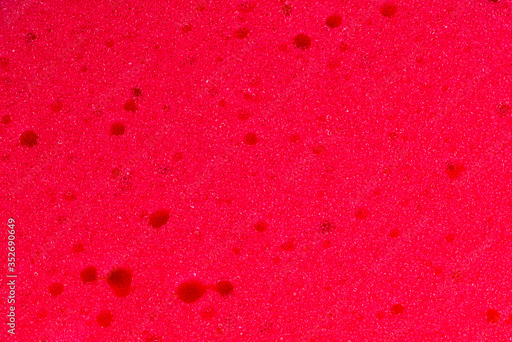 Red color bath sponge texture. Abstract surface of sponge as a solid background Red color bath sponge texture. Abstract surface of sponge as a solid background