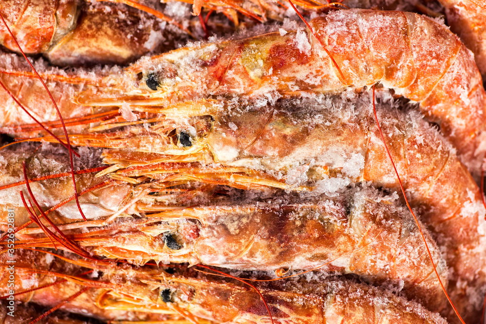 Fresh red shrimps or prawn packing in box on slate stone background. Seafood, top view, flat lay, copy space Fresh red shrimps or prawn packing in box on slate stone background. Seafood, top view, flat lay, copy space