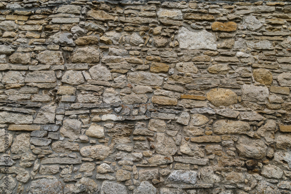 Cobblestone texture.Marble and granite drainage system closeup.Concrete wall with gravel. Gray foundation of the house.