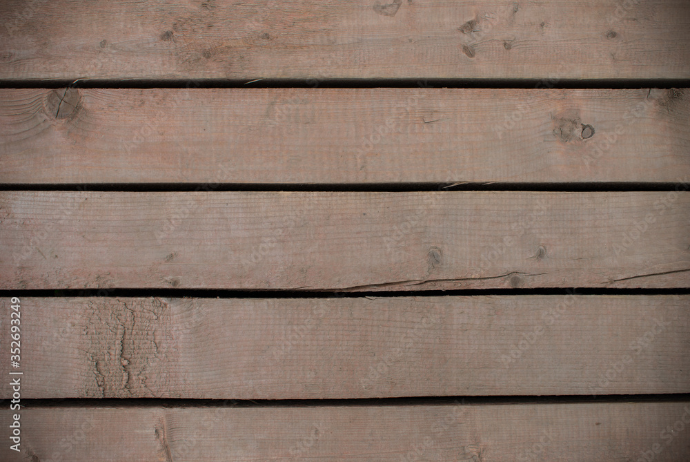 Fototapeta premium Brown wood boards with holes between them texture. Background for design