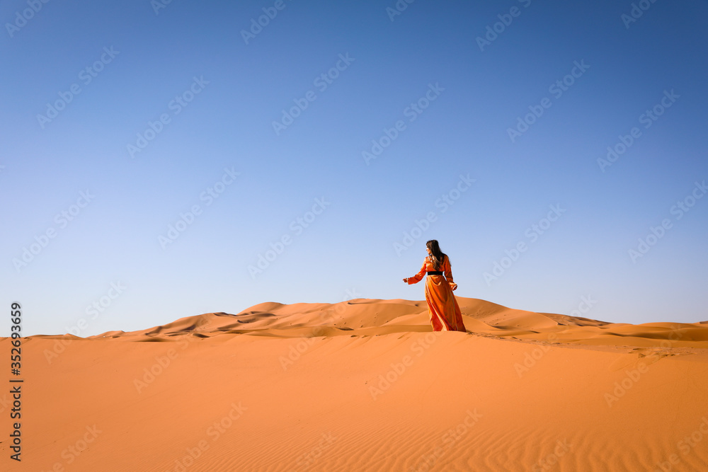 A girl in a beautiful Moroccan dress. Merzouga Morocco.