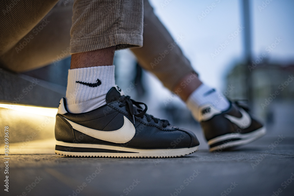 Young man wearing Nike Cortez shoes Stock Photo | Adobe Stock