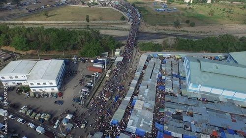 Aerial view over crowd of Haitians crossing border to go to Dajabon market photo