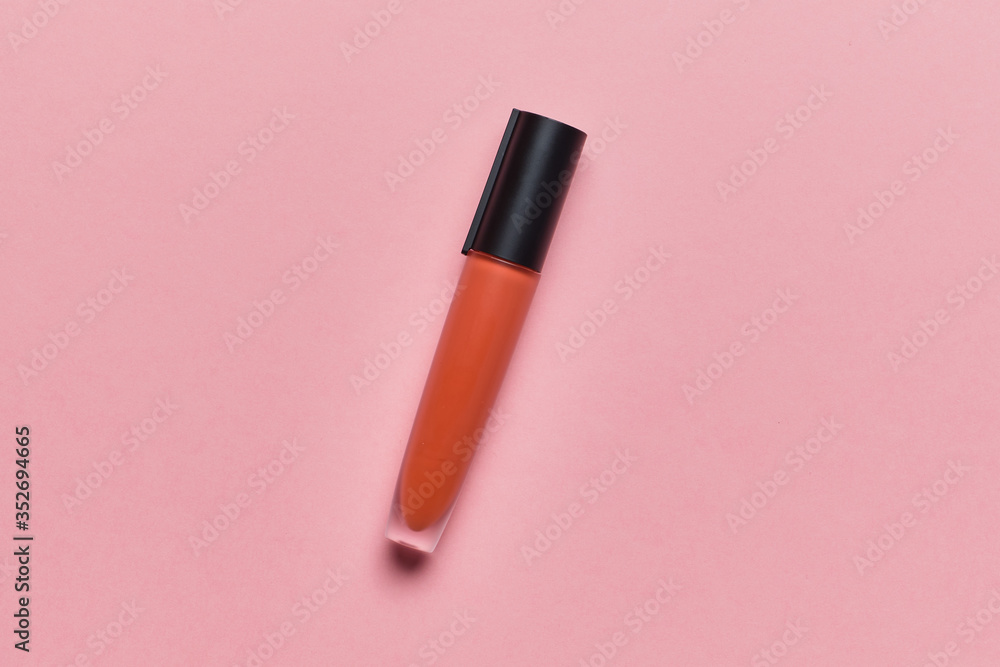 Tube with liquid lipstick on a pink background with a top view Tube with liquid lipstick on a pink background with a top view