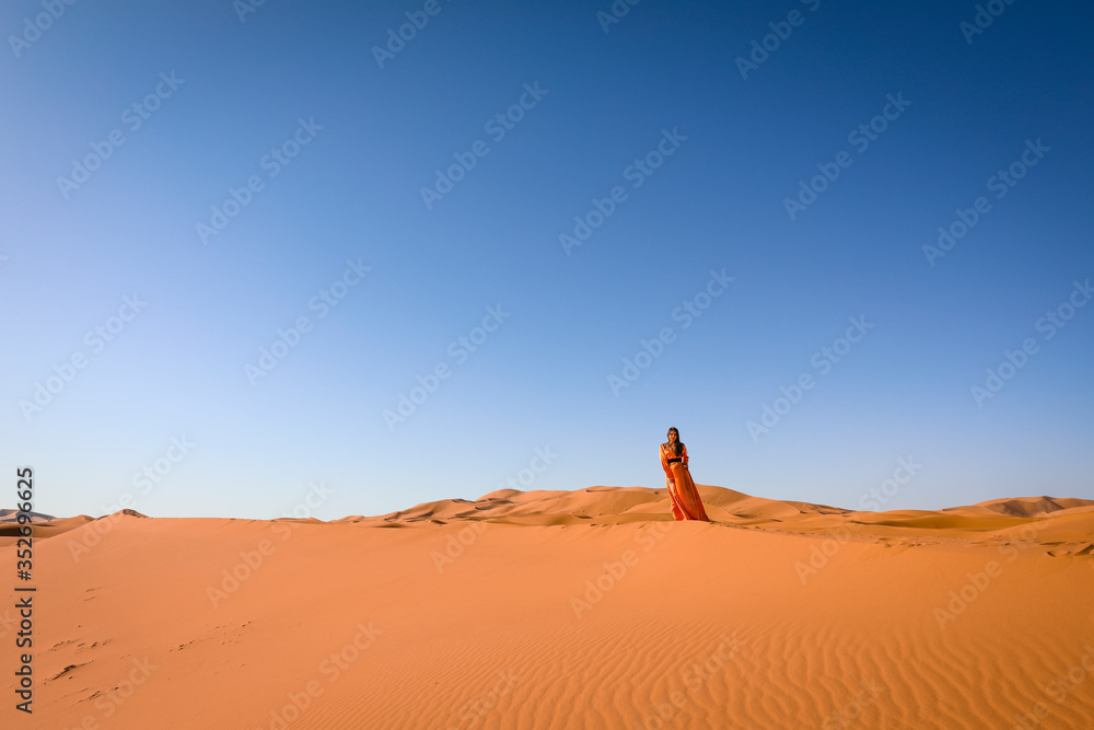A girl in a beautiful Moroccan dress. Merzouga Morocco. A girl in a beautiful Moroccan dress. Merzouga Morocco.