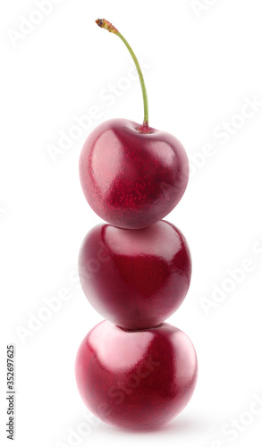 Isolated stack of cherries. Pyramid of three fresh cherries on top of each other isolated on white background