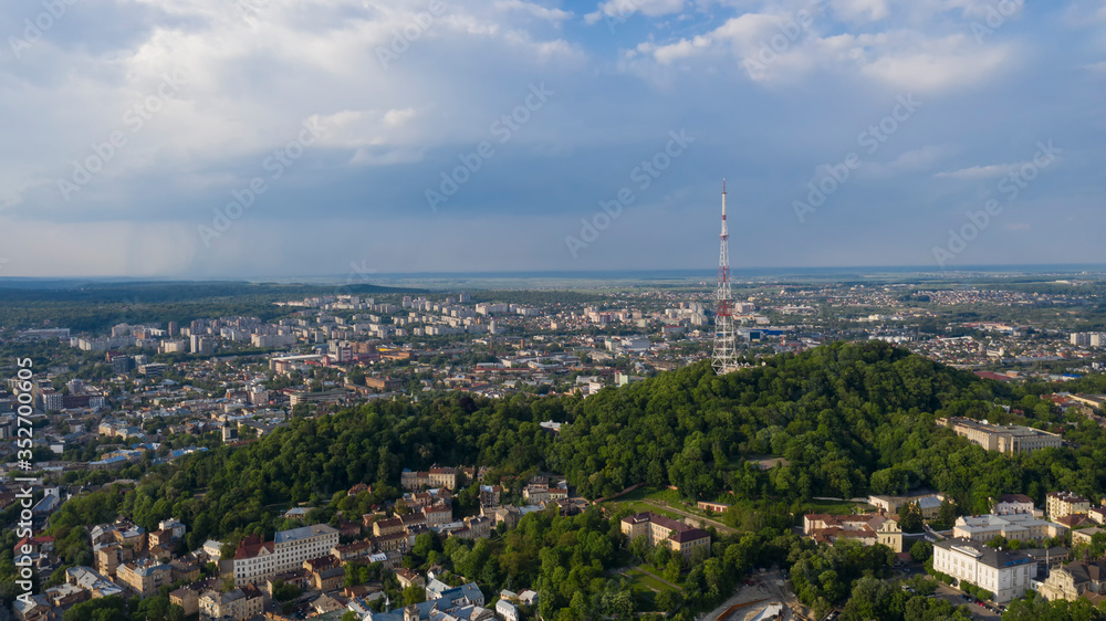 Closeup of television tower in Lviv. Summer aerial drone view in june 2019. Mountain Vysokyi Zamok in Lviv, Ukraine.