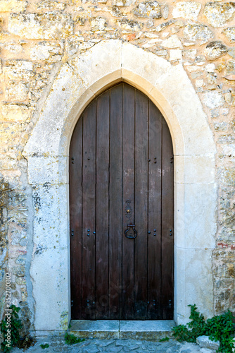 Closed wooden door of medieval fortress in Europe © rostovdriver