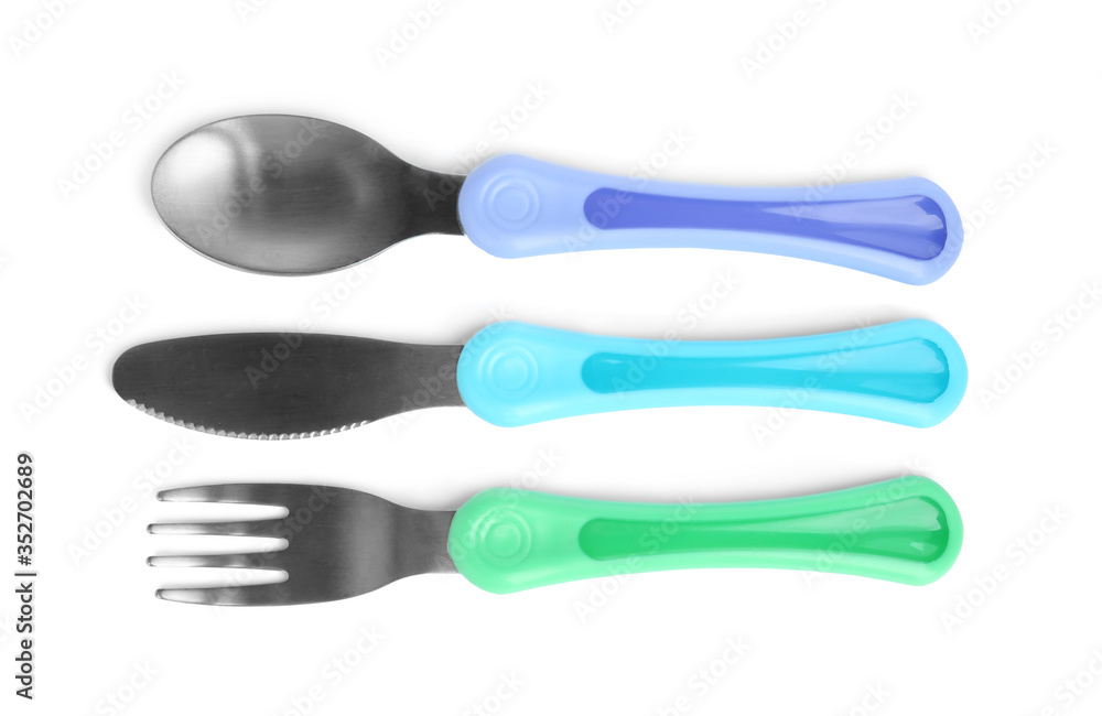 Set of small cutlery isolated on white, top view. Serving baby food Set of small cutlery isolated on white, top view. Serving baby food