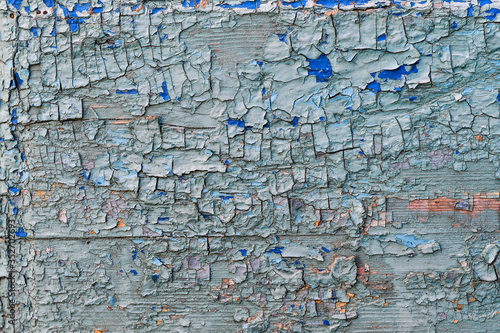 Blue wooden background with cracked paint.