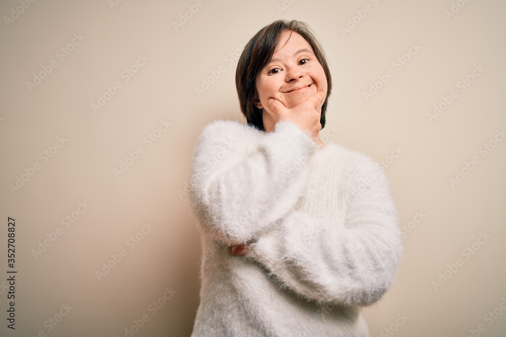 Young down syndrome woman standing over isolated background looking confident at the camera smiling with crossed arms and hand raised on chin. Thinking positive. Young down syndrome woman standing over isolated background looking confident at the camera smiling with crossed arms and hand raised on chin. Thinking positive.