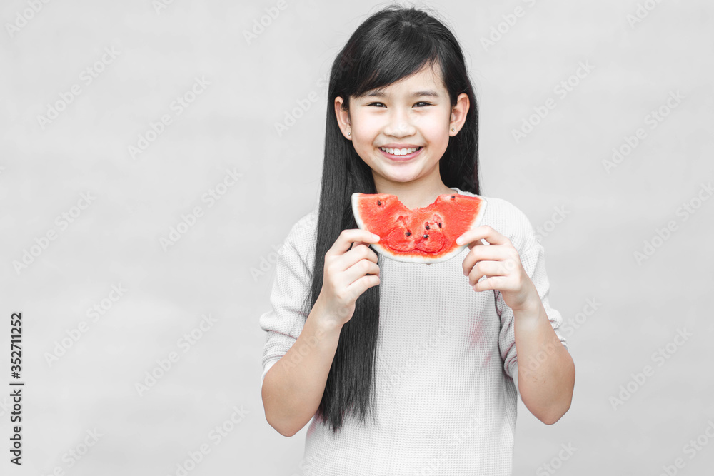 Portrait of a little girl with watermelon, summer isolated on gray background. Portrait of a little girl with watermelon, summer isolated on gray background.