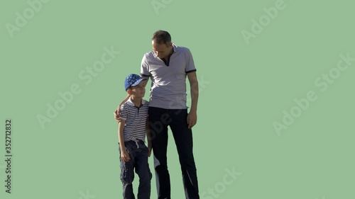 A man stands with a small boy and looks together at something. Footage with alpha channel