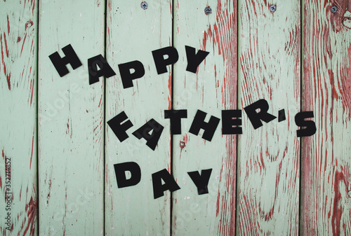 happy father's day written on wooden floor for father's day photo