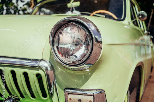 Headlamp of tuned old vintage car, close up. Low rider auto.