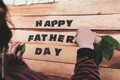 happy father's day written on wooden floor for father's day photo