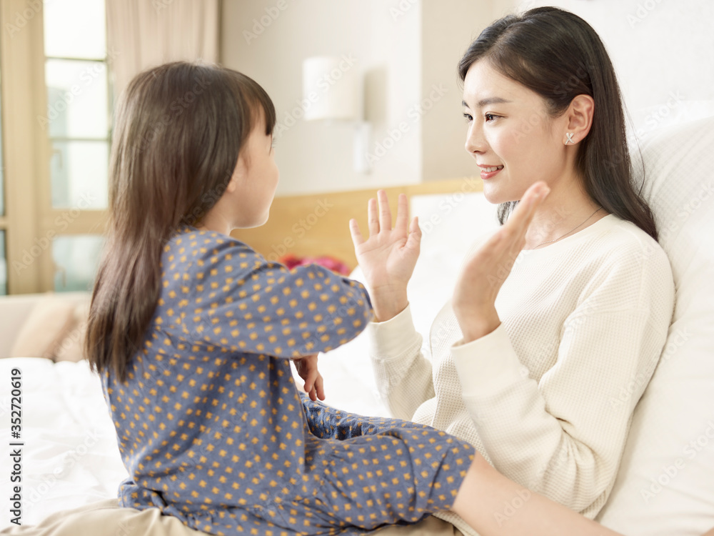 asian mother and child having a good time chatting at home asian mother and child having a good time chatting at home