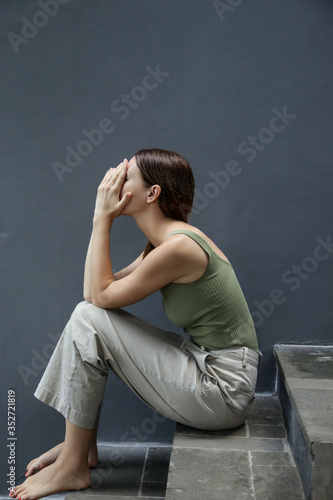 Portrait of depressed woman, covering face with her hands