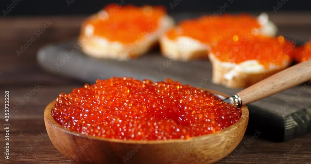 Red caviar in a plate and of sandwiches slowly rotate. Red caviar in a plate and of sandwiches slowly rotate.