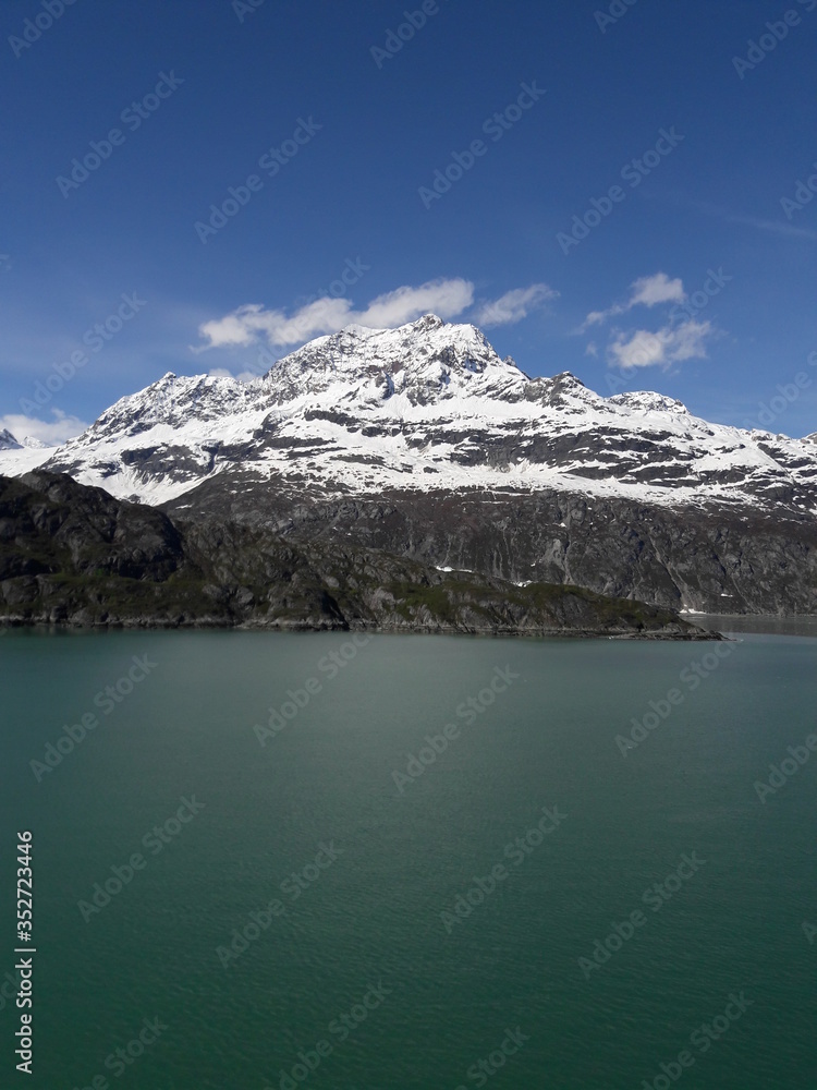 Alaska glacier, lake, canal, mountains and snow with a clear blue sky on a sunny spring day 2018