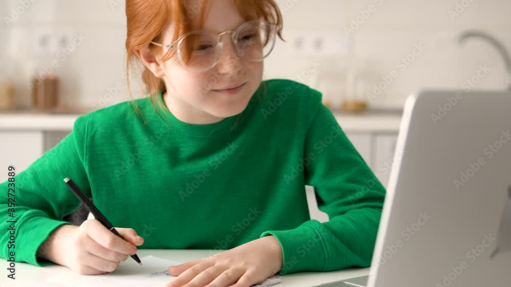Diligent pupil doing homework following all instructions of online teacher Diligent pupil doing homework following all instructions of online teacher