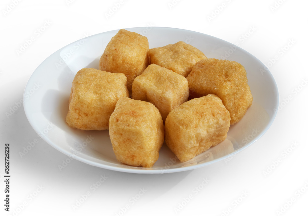Group of brown tofu puff with plate isolated on white. Group of brown tofu puff with plate isolated on white.