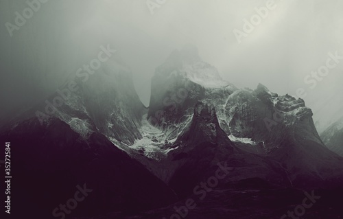 Mountain peaks of Torres del Paine in Patagonia National Park Chile, peaks covered in fog. 