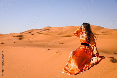 A girl in a beautiful Moroccan dress. Merzouga Morocco. photo