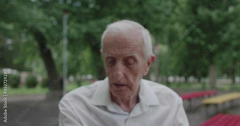 Senior man makes a move of chess and talks while playing with friend at leisure Senior man makes a move of chess and talks while playing with friend at leisure