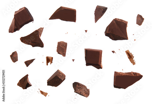 Cracked chocolate parts from top view isolated on white background