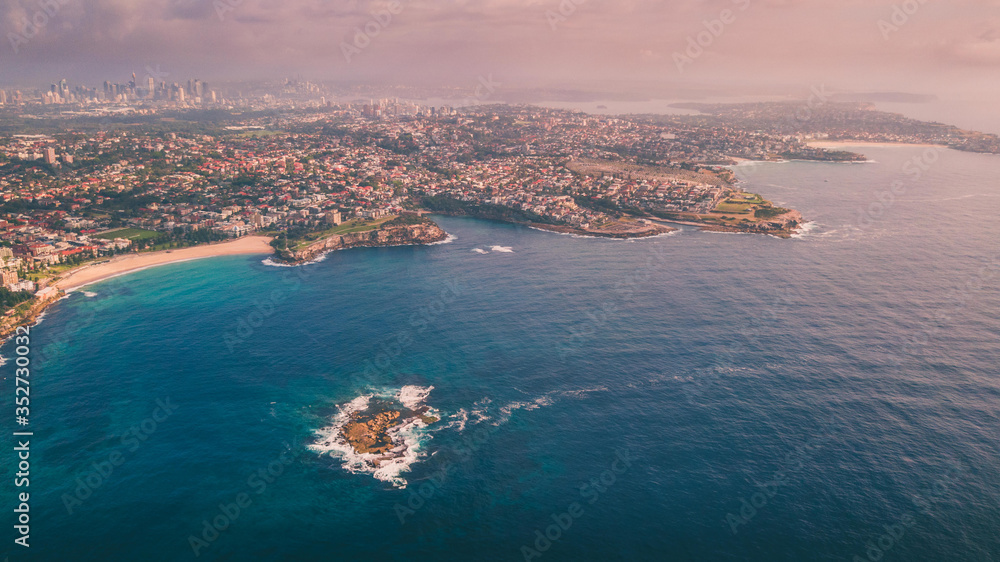 Aerial view of Sydney coastline from above with Sydney CBD in the background