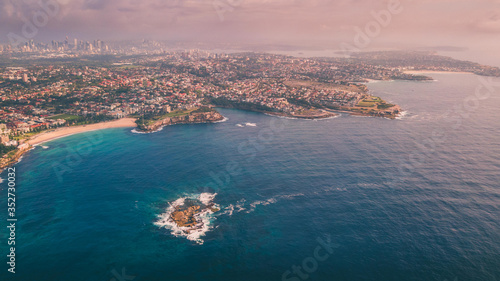 Aerial view of Sydney coastline from above with Sydney CBD in the background