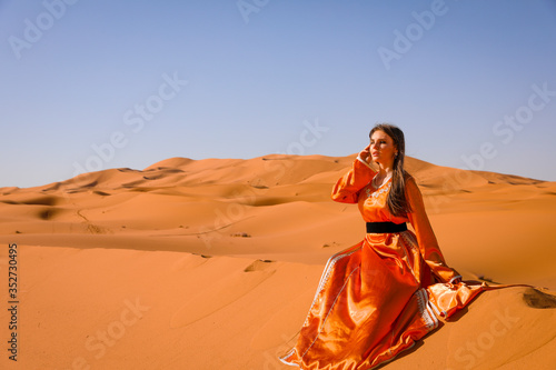 A girl in a beautiful Moroccan dress. Merzouga Morocco.