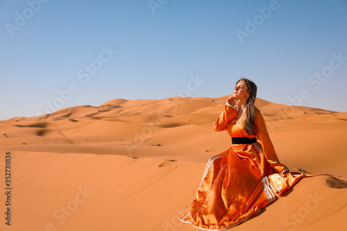 A girl in a beautiful Moroccan dress. Merzouga Morocco.