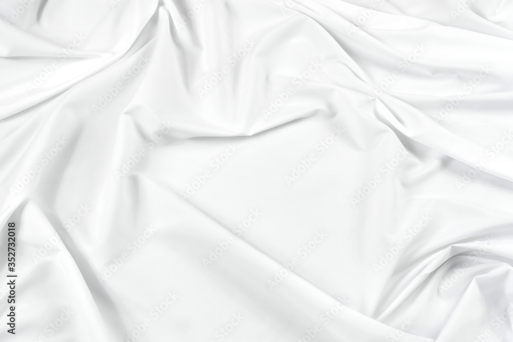 Abstract white fabric texture background. Cloth soft wave. Creases of satin, silk, and cotton.	