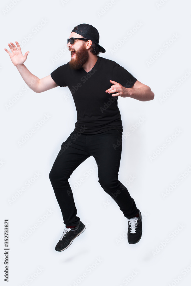 Full length photo of young bearded man jumping