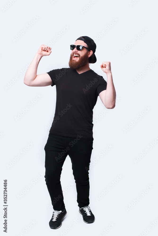 Full length photo of amazed bearded hipster man celebrating success Full length photo of amazed bearded hipster man celebrating success