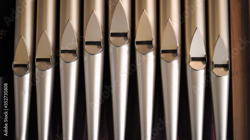 Close up and tilt of old musical intrument pipe organ tubes. photo