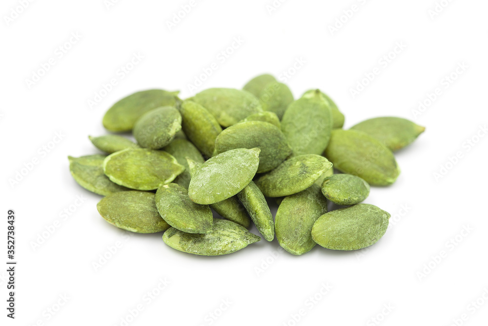 Organic roasted pumpkin seed or pepita on white isolated background, closeup side view. Pumpkin