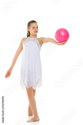 Girl gymnast performs exercises with the ball.