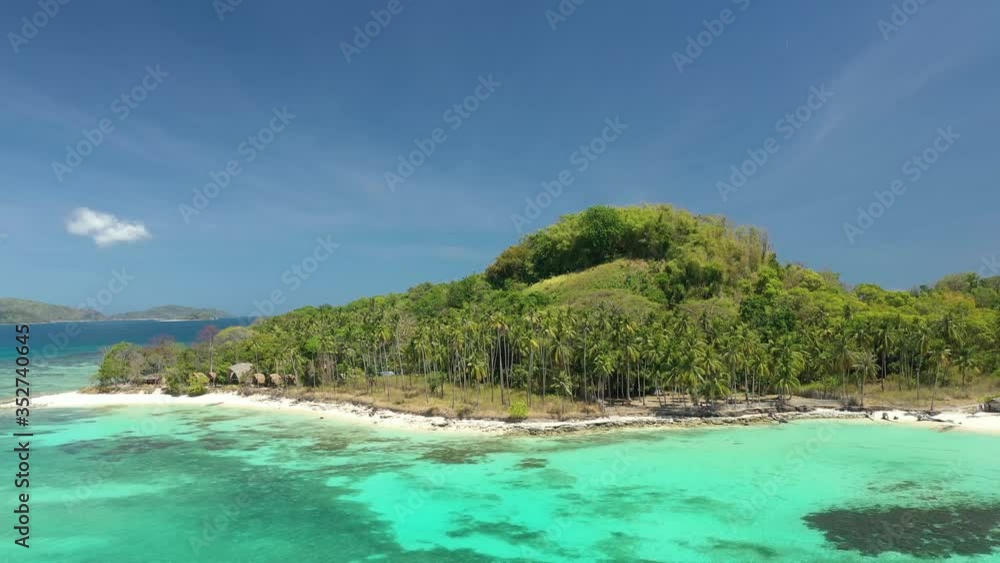 Darocotan island Philippines with shipwreck seen beneath the water, Aerial dolly out reveal shot Darocotan island Philippines with shipwreck seen beneath the water, Aerial dolly out reveal shot
